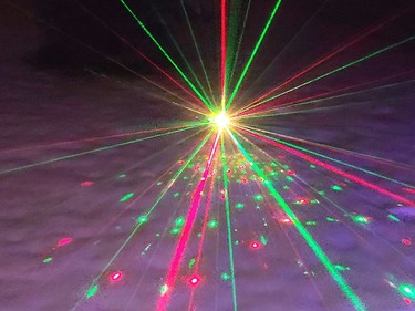 A Christmas laser light show at a home on Greenwood Road on a foggy day in December. Anthony Dixon