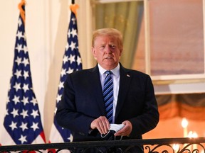 U.S. President Donald Trump poses on the Truman Balcony of the White House after returning from being hospitalized at Walter Reed Medical Center for COVID-19 treatment, in Washington, D.C., on Oct. 5.