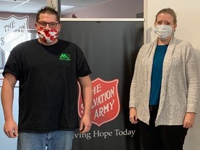 Matt Reid is pictured with Daphne Bourque, family and community service supervisor at the Sarnia Salvation Army earlier this month. The Sarnia handyman and yard maintenance contractor is encouraging others who can to donate to local charities. (Submitted)