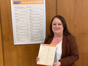 Sarnia customer service manager Andrea Lane poses with a poster and brochure used to help people identify their language for interpretation services using Language Line Solutions. The city has offered the service since November. (Submitted)
