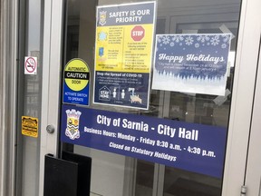 The entrance to city hall, with warnings about COVID-19, is seen here on Sunday December 20, 2020 in Sarnia, Ont. (Terry Bridge/Sarnia Observer)