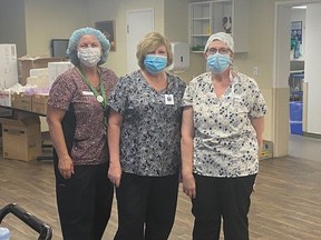 Bluewater Health chief nursing executive Shannon Landry, middle, is pictured at Vision Nursing Home in May with Bluewater Health food services workers Lisa Mina, left, and Marjorie Breuer. The hospital group and various community partners have teamed up to develop a new system to pre-empt and react quickly to potential problems in retirement and nursing homes, to keep patients from having to be admitted to hospital if services are impacted by the effects of COVID-19. (Submitted)