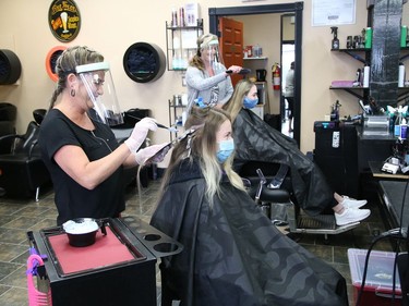 Lisa Comisso, left, adds highlights to Melissa Belanger's hair, while Danielle Cote styles Abby Redmond's hair at Hair Central Sudbury on Durham Street on June 12. Local barber shops, hair salons and hairdressers/stylists were allowed to welcome customers again as part of the Ontario government's Stage 2 reopening plan. John Lappa/Sudbury Star