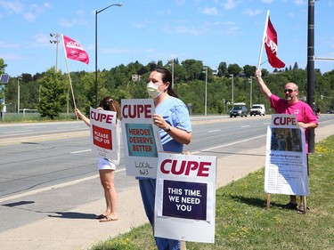 Members of CUPE Local 1623, representing various local hospital workers, take part in a rally on Paris Street near the entrance to Health Sciences North in Sudbury, Ont. on Friday July 17, 2020. The protest was part of province-wide rallies held to put pressure on the Ontario government to "restore basic workplace rights suspended for months by emergency orders during the COVID-19 pandemic. Bill 195 continues that suspension of these rights for up to 3 years," said a release from CUPE. John Lappa/Sudbury Star/Postmedia Network