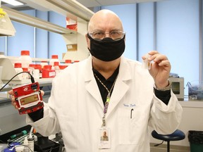 In this file photo, Jeff Sutton, founder and president of Verv Technologies in Sudbury, Ont., holds his blood plasma separation invention (right) and a digital microfluidic analyzer. He says money from the Nickel Basin Federal Economic Development Corporation has helped his company get started.