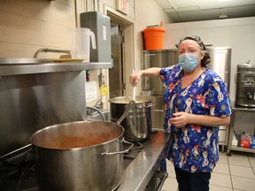 Kitchen manager Christine Newbury, of the Elgin Street Mission, prepares hot meals for 200 mission clients for curbside pick-up in Sudbury, Ont. on Tuesday December 15, 2020. Meals are available at the Elgin Street Mission seven days a week from 5:30 p.m. to 7 p.m.