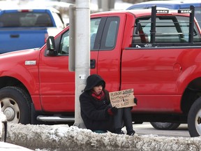 A person panhandles at the intersection of Paris Street and Regent Street in Sudbury on Dec. 16.