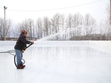 Joe Caridade floods the rink at Robinson Playground in Sudbury, Ont. on Wednesday December 16, 2020. Caridade has been taking care of the ice surface at the playground for more than 35 years. John Lappa/Sudbury Star/Postmedia Network