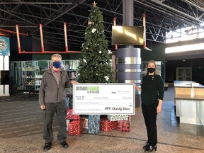 Al Hooper, Work Centre Manager for OPG's North Bay and Coniston facilities, presents a cheque to Ashley Larose, Science North's Director of Development.