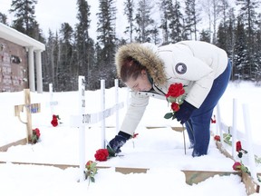 Nicole Robbins, one of the Timmins members of No More, places a flower in front one of the crosses during a memorial service which was held at Timmins Memorial Cemetery on Pine Street South Tuesday. The service, organized by No More, provided an opportunity to remember loved ones who lost their lives to drug overdose.

RICHA BHOSALE/The Daily Press