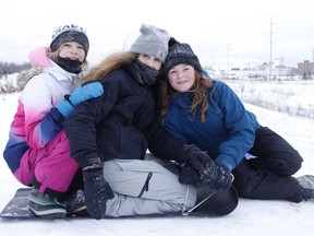 The sliding hill just off Highway 655 at the end of Ross Avenue is always a popular draw during the Christmas/New Year's holiday break. Among those out tobogganing on Monday were, from left, Kylie Pineault, Emelie Chartrand and Danielle Belanger.

RICHA BHOSALE/The Daily Press