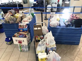 Staff at Vanden Bussche Irrigation collected 1,240 pounds of food during a three-week holiday food drive for the Delhi Sharing Pantry, and company president Marc Vanden Bussche matched it in dollars, presenting $1,240 to the Sharing Pantry last week. (Contributed photo)