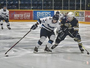 Crunch's Alexander Thompson #77 attempts to keep the puck away from the Gold Miners.
Game photo by Allyson Demers .TP.jpg
