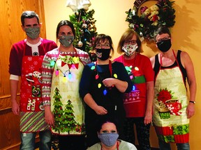 Pictured here, from left, are turkey dinner volunteers Dakota Mattson, Nicole Larson, Lynn Jones, Sandy Stoddard, and Connie Clement, with Jenn Lievaart sitting.