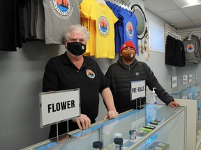 The Reef Store's manager, Pat Brett, left stands with Wauzhushk Onigum Chief Chris Skead at the new cannabis shop which recently opened. It is the first cannabis retailer in the Kenora area. R