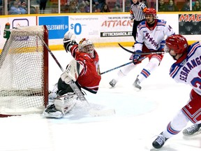 Attack goaltender Mack Guzda stretches out as Donovan Sebrango fires a shot over the net after getting a pass from teammate Serron Noel during a second-period rush. The Owen Sound Attack hosted the Kitchener Rangers inside the Harry Lumley Bayshore Community Centre Feb. 29, 2020.