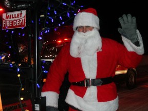 Santa Claus popped into Millet to help the Millet Fire Dept. collection donations for the Millet Community Food Bank and the Millet Lions Club hampers Thursday in a mini parade around the community.Christina Max