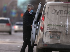 A Dynacare employee transports items away from Parkview personal care home, in Winnipeg on Tuesday, Dec. 1, 2020. Chris Procaylo/Winnipeg Sun