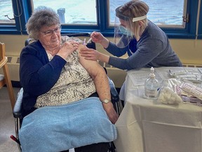 St. Paul Extendicare resident Cecile Kotowich receives one of the first doses of the COVID-19 vaccine, administered by RN Melissa Dobrowski from Bonnyville Community Health Services. Photo courtesy Alberta Health Services