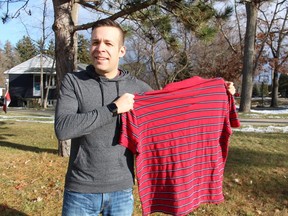 Sarnia's Matt Moore holds up a T-shirt from the early days of 2020 when he was more than 100 pounds heavier.