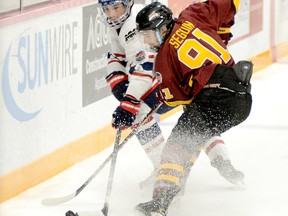Timmins Rock Captain Derek Seguin, shown here battling for a loose puck along the boards with Rayside-Balfour Canadians blue-liner Avery Chisholm during an NOJHL game at the McIntyre Arena on Nov. 28, has been named the NOJHL’s Forward of the Month for December. In addition, Rock blue-liner Brendan Boyce captured Defenceman of the Month honours and Tyler Masternak garnered honourable mention for Goalie of the Month. THOMAS PERRY/THE DAILY PRESS