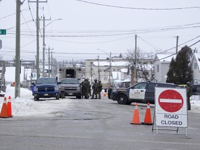 Tactical unit officers are seen clustered in front of a Sixth Avenue residence where a single shot was fired Monday night.

RICHA BHOSALE/The Daily Press