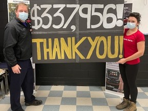 GM Cami recently donated more than $300,000 to United Way branches in Oxford and Elgin-Middlesex. Pictured, Kennedy Atkinson, CAMI United Way Hourly Chair and Jon Nunn, CAMI United Way Salary Chair, revealing the donation total. (Courtesy United Way Oxford)