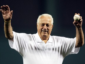 Before throwing out the ceremonial first pitch, Los Angeles Dodgers legend Tommy Lasorda acknowledges the crowd before Italy takes on Venezuela in the first round of the World Baseball Classic on March 8, 2006 at The Ballpark at Disney in Kissimmee, Florida.  (Photo by Doug Benc/Getty Images)