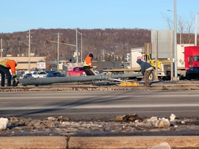 A traffic light is removed from the Bypass, Friday afternoon, at Algonquin Avenue. Police say a vehicle struck the traffic light. The driver's condition is unknown at this time. Michael Lee/The Nugget