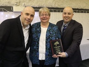 In a dated photo Grande Prairie Minor Hockey Association president DJ Golden and Grande Peace Athletic Club president Tyler Stojan present Lorna LeBlanc with a plaque for her 15 years of work with the GPAC club. On Jan. 3, Leblanc, the executive director of the GPMHA,  hit the 25-year mark of service to minor hockey in the Swan City.