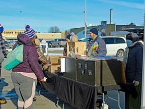 Darryl Kuepfer, a vendor with the North Bay Farmers' Market, chats with some shoppers Saturday after the market had to set up outside North Bay Mall.
PJ Wilson/The Nugget