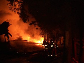 Firefighters battle a house fire on Parkside Avenue at Beford lake on the evening of Saturday, January 9, 2021.