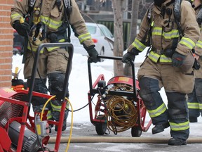 Firefighters move ventilation equipment following a fire in a basement apartment at 155 Willow Ave., on Saturday, Jan. 9, 2020 in Sault Ste. Marie, Ont. (BRIAN KELLY/THE SAULT STAR/POSTMEDIA NETWORK)