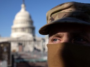 DC National Guard CMSgt Allan Gilbreath stands guard outside the east side of the U.S. Capitol on Jan. 07, 2021 in Washington, DC. Supporters of President Trump had stormed and desecrated the building the day before as Congress debated the a 2020 presidential election Electoral Vote Certification. (Photo by John Moore/Getty Images)