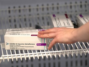 Boxes of the Oxford/AstraZeneca COVID-19 vaccine are pictured in a refrigerator at a NHS mass coronavirus vaccination centre at Robertson House in Stevenage, Hertfordshire, Britain on Jan. 11. Joe Giddens/Pool via REUTERS