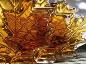 In this Oct. 27, 2011 file photo, bottles of maple syrup sit in a window in East Montpelier, Vt. The U.S. Department of Agriculture said maple syrup production was up in the 2015 season. Vermont continues to lead the nation by far, producing most of the syrup in the country, followed by New York and Maine. (AP Photo/Toby Talbot, File)
