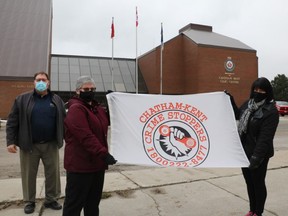 Handout/Chatham Daily News
The Chatham-Kent Crime Stoppers flag has been raised at the Chatham-Kent Civic Centre to mark January as Crime Stoppers month. Const. David Bakker, outgoing police co-ordinator, left, incoming civilian co-ordinator Nancy Galbraith, middle, and board chair Angie Shreve took part in the flag raising.