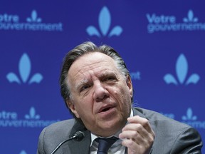 CP-Web.  Quebec Premier Francois Legault responds to a question during a news conference in Montreal on Wednesday, December 16, 2020. THE CANADIAN PRESS/Paul Chiasson ORG XMIT: pch105