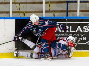 Blake Murray (88) lays a hit while playing for Surahammars IF of Hockeyettan in Sweden on Sunday, January 10, 2021.