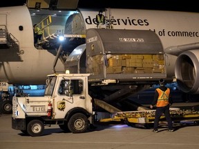 Canada's first batch of Pfizer/BioNTEch COVID-19 vaccines are unloaded from a UPS cargo plane at Montreal-Mirabel International Airport in Montreal on Dec. 13.