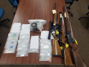 A search of two residences by the Ontario Provincial Police, Greater Sudbury Police Service and North Bay Police Service, Thursday, resulted in the seizure of three firearms and approximately $12,000 worth of drugs. Four people are charged. Ontario Provincial Police Photo