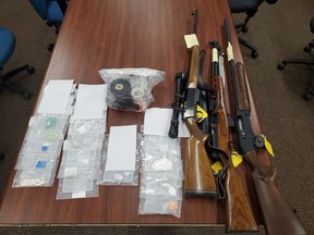 A search of two residences by the Ontario Provincial Police, Greater Sudbury Police Service and North Bay Police Service, Thursday, resulted in the seizure of three firearms and approximately $12,000 worth of drugs. Four people are charged. Ontario Provincial Police Photo