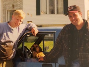 Eric Brombacher and Jon Ferguson, shown here circa 1995, worked together to create two new songs.  Brombacher's dog, Sammy, is between the two friends. SUPPLIED