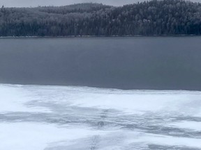 Snowmobile tracks lead to open water in this file photo.