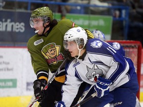 North Bay Battalion Mike Amadio keeps in close check with Sudbury Wolves captain Kevin Raine during OHL action from the Sudbury Community Arena on Sunday December 15/2013.