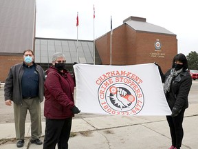 The Chatham-Kent Crime Stoppers flag has been raised at the Chatham-Kent Civic Centre to mark January as Crime Stoppers month. Const. David Bakker (left), outgoing police co-ordinator, incoming civilian co-ordinator Nancy Galbraith and board chair Angie Shreve took part in the flag raising. Handout/Chatham This Week