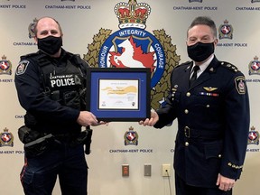 Const. Jason Herder, left, receives the Law Enforcement Torch Run for Special Olympics Ontario's Award of Honour from Chatham-Kent police Chief Gary Conn in Chatham, Ont., on Tuesday, Jan. 19, 2021. (Chatham-Kent Police Service Photo)
