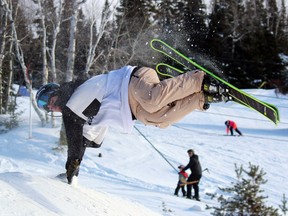 Shawn Ralko goes horizontal as he drags his hands on a jump during the best trick contest Shredtopia event at Mount Evergreen Ski Club in 2019. The local ski hill is currently shuttered due to provincial restrictions amid the COVID-19 pandemic.