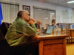 Councillor Kirk Soroka sits between plexiglass barriers to protect him from COVID-19 at Cold Lake city council on Nov. 17, 2020.