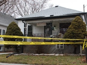 Yellow police tape is shown Sunday around a house on Essex Street in Sarnia. Sarnia police are investigating the death of an adult female as a homicide.